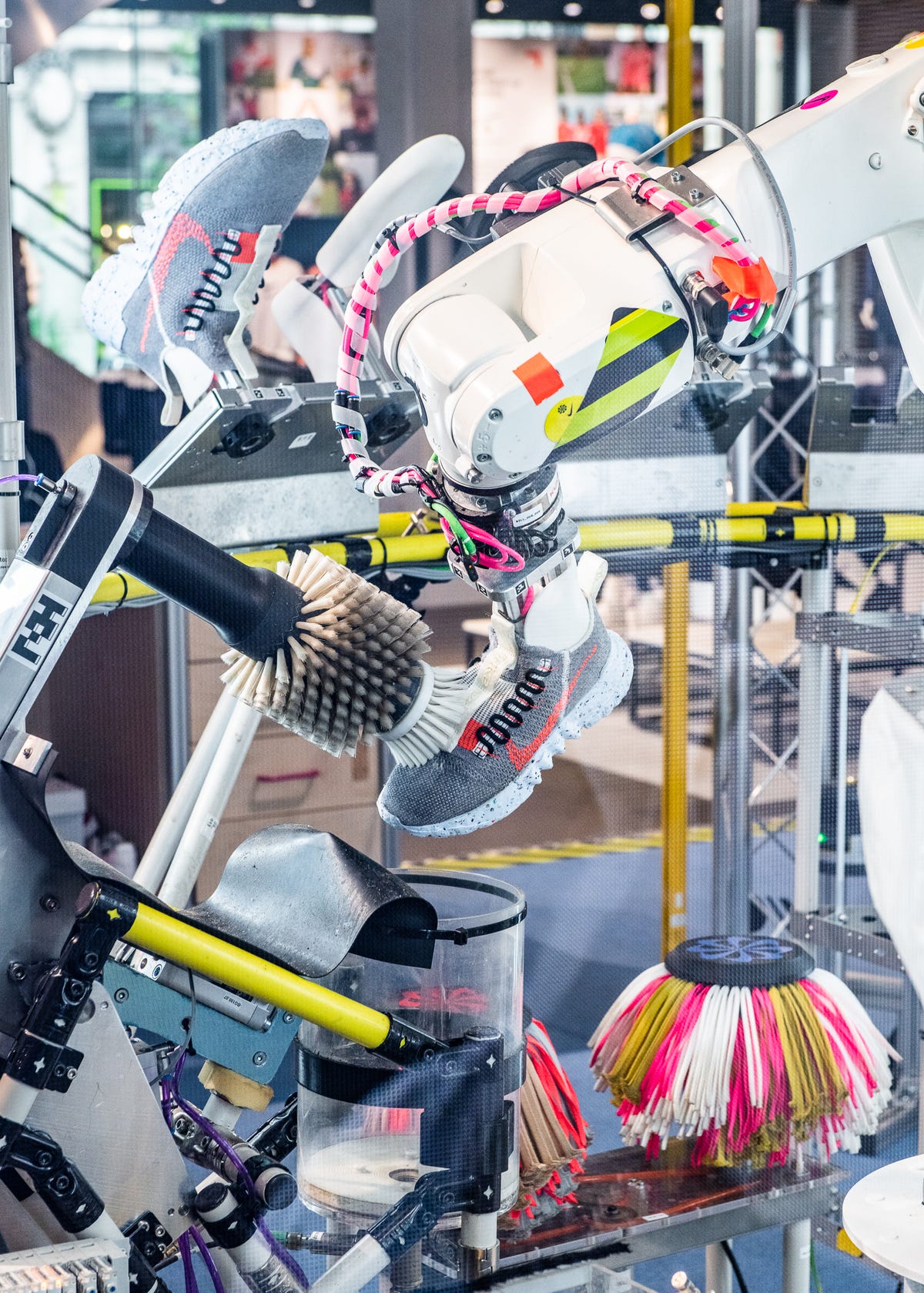 A round brush cleans a sneaker in Nike's B.I.L.L. shoe-cleaning machine